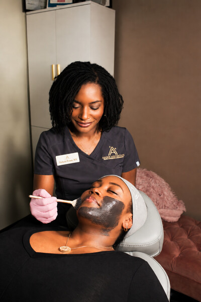 Provider applying a charcoal mask